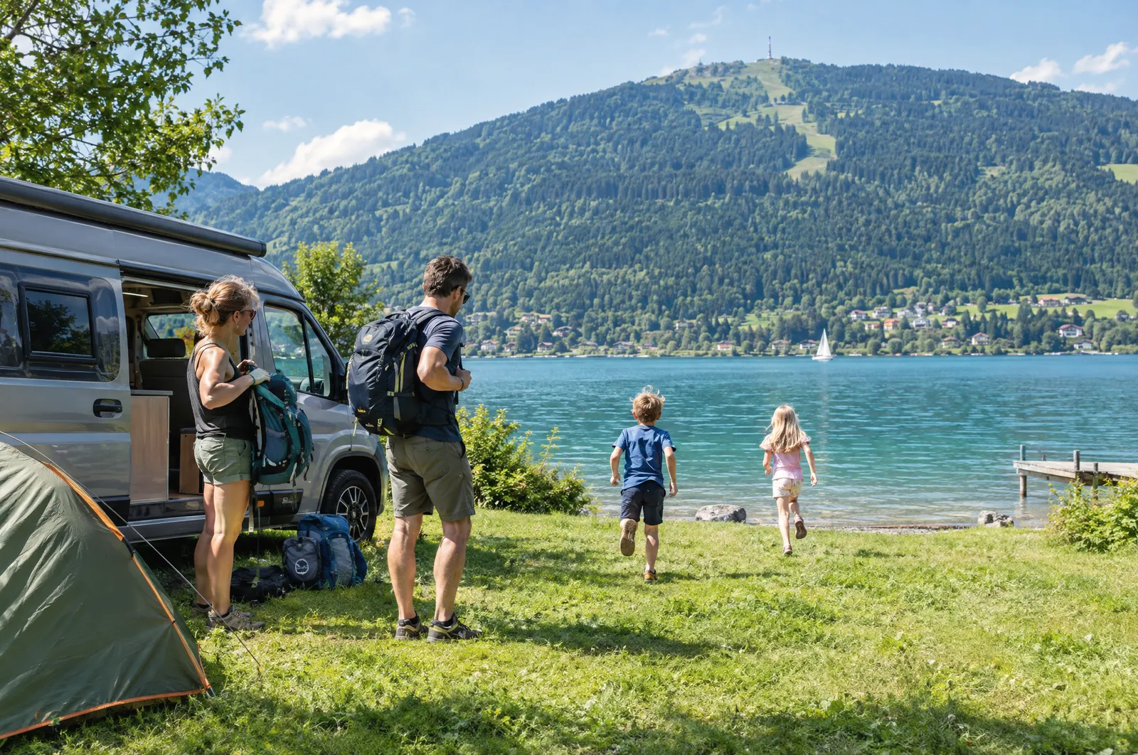 A family with a camper van and tent at a campsite on the Ossiacher See, with the Gerlitzen behind